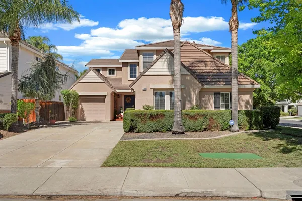 a front view of a house with a garden