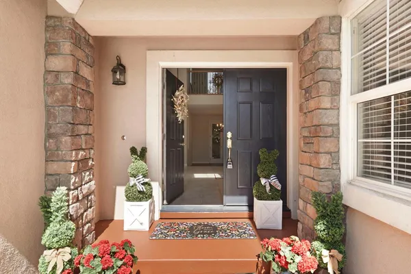 a dining room with furniture a chandelier and wooden floor