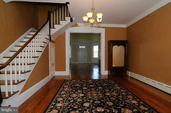 1059 Cumberstone Road Harwood, MD 20776 - Photo 11 of 26 a view of a hallway with wooden floor and staircase