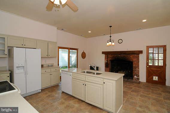 1059 Cumberstone Road Harwood, MD 20776 - Photo 14 of 26 a kitchen with white cabinets and stainless steel appliances