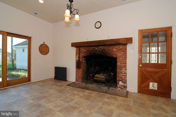 1059 Cumberstone Road Harwood, MD 20776 - Photo 15 of 26 an empty room with fireplace and windows