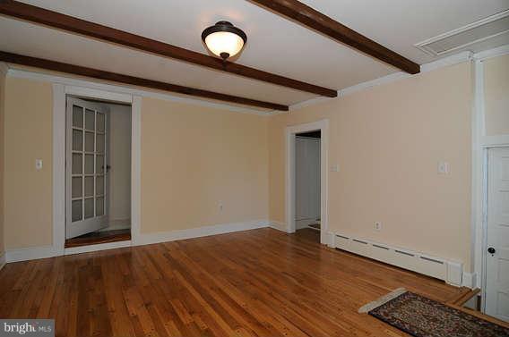 1059 Cumberstone Road Harwood, MD 20776 - Photo 17 of 26 an empty room with wooden floor and windows