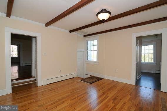 1059 Cumberstone Road Harwood, MD 20776 - Photo 18 of 26 an empty room with wooden floor cabinet and windows