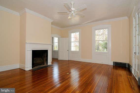 1059 Cumberstone Road Harwood, MD 20776 - Photo 23 of 26 an empty room with wooden floor a fireplace and windows