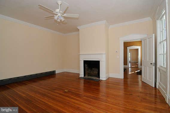 1059 Cumberstone Road Harwood, MD 20776 - Photo 24 of 26 a view of a livingroom with wooden floor and a ceiling fan