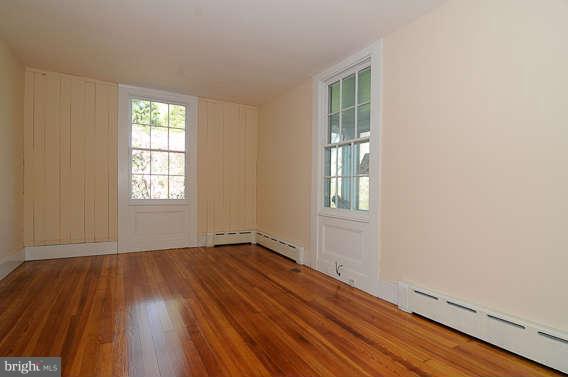 1059 Cumberstone Road Harwood, MD 20776 - Photo 8 of 26 an empty room with wooden floor and windows