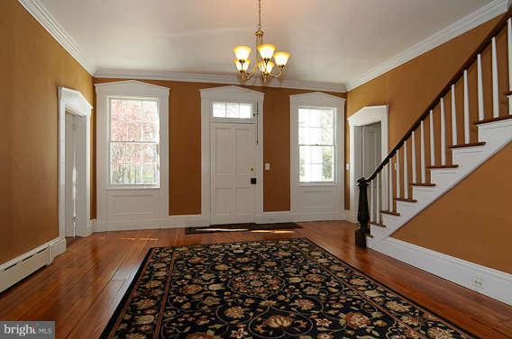 1059 Cumberstone Road Harwood, MD 20776 - Photo 10 of 26 a view of entryway with stairs and wooden floor