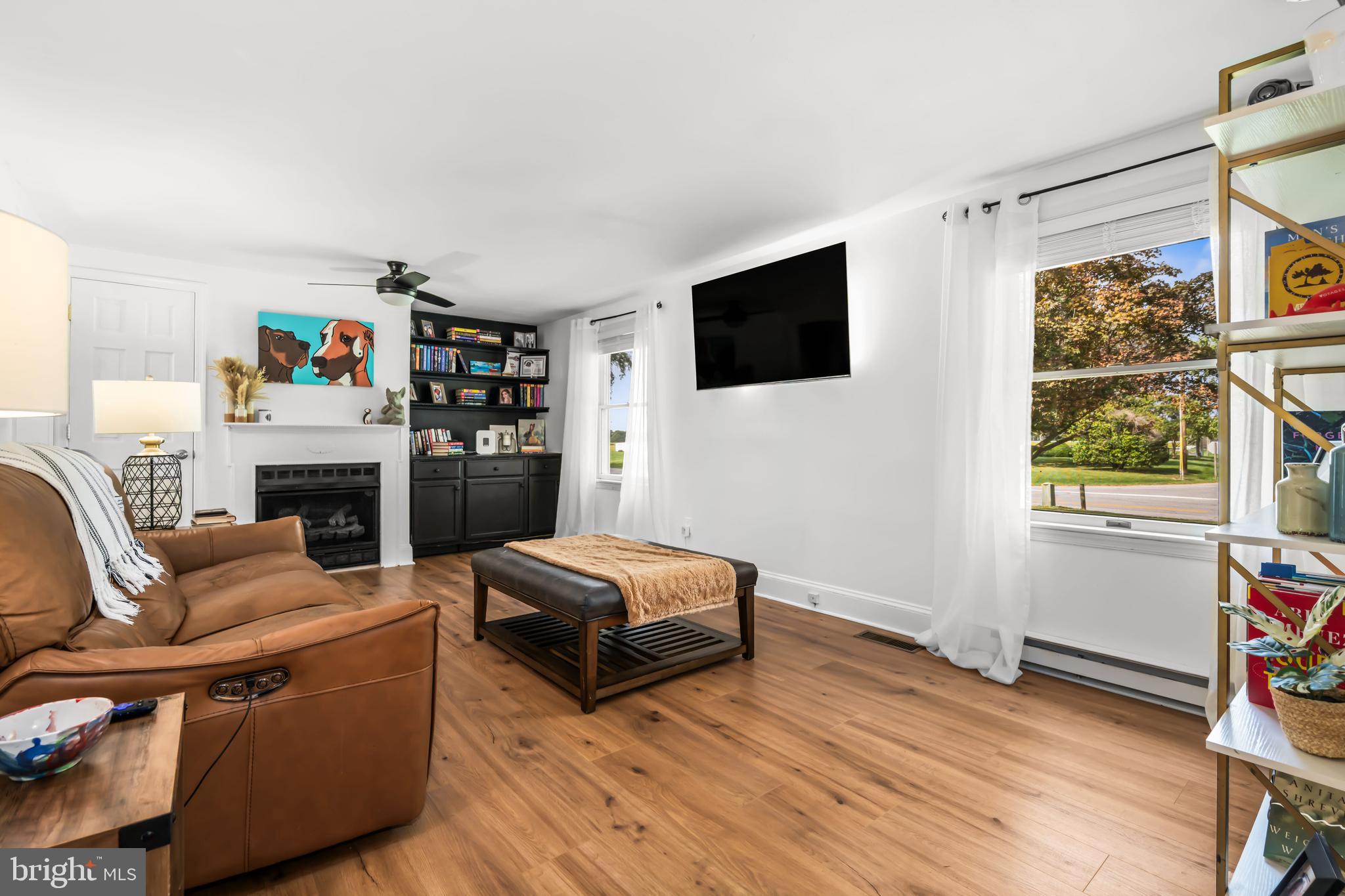 7653 Broad Neck Road Chestertown, MD 21620 - Photo 15 of 39 a living room with fireplace furniture and a flat screen tv