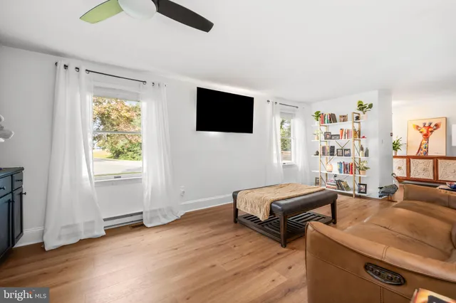 a kitchen with stainless steel appliances granite countertop a refrigerator a stove top oven a sink dishwasher and white cabinets with wooden floor