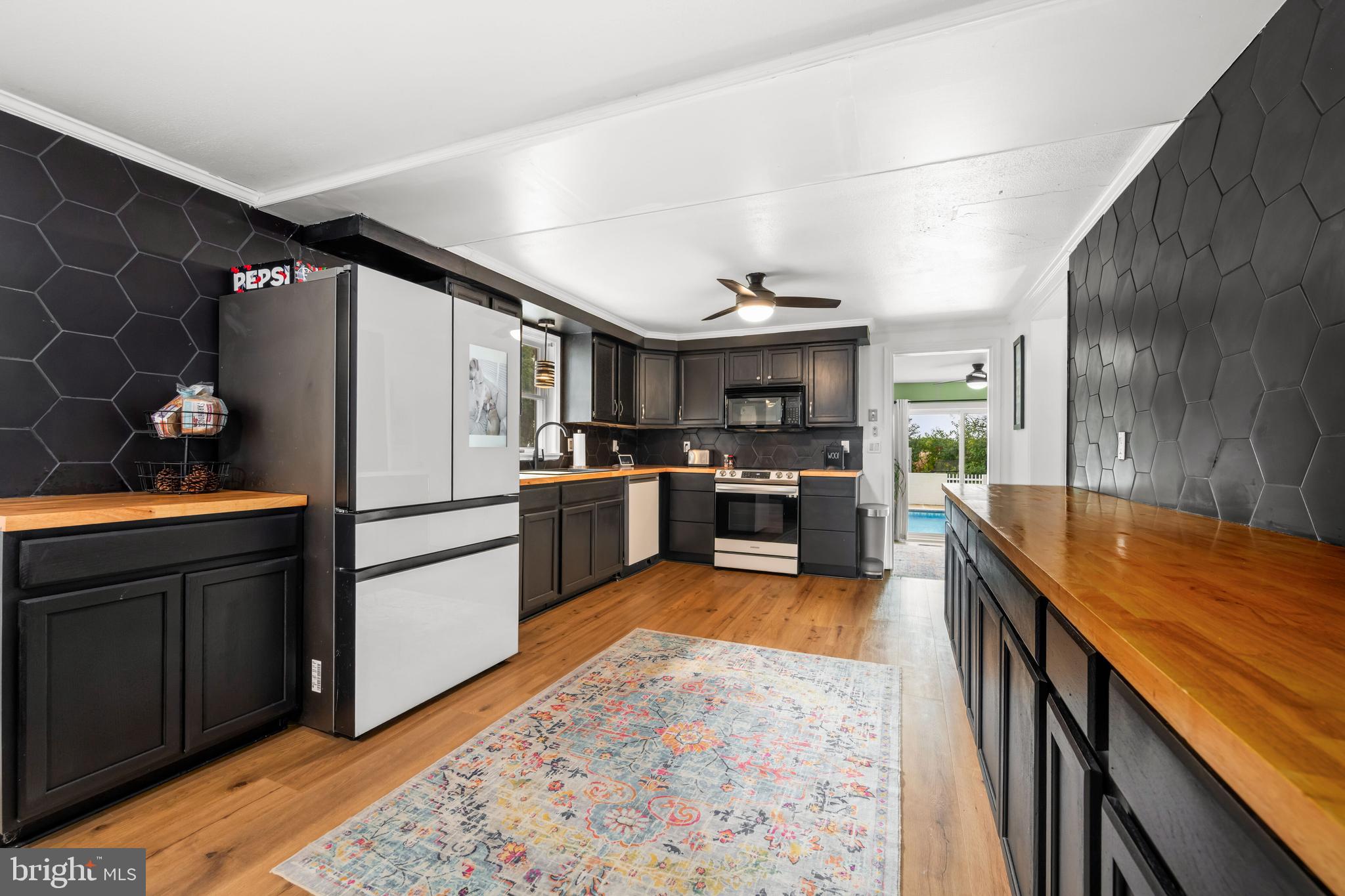 7653 Broad Neck Road Chestertown, MD 21620 - Photo 20 of 39 a kitchen with granite countertop stainless steel appliances and wooden cabinets