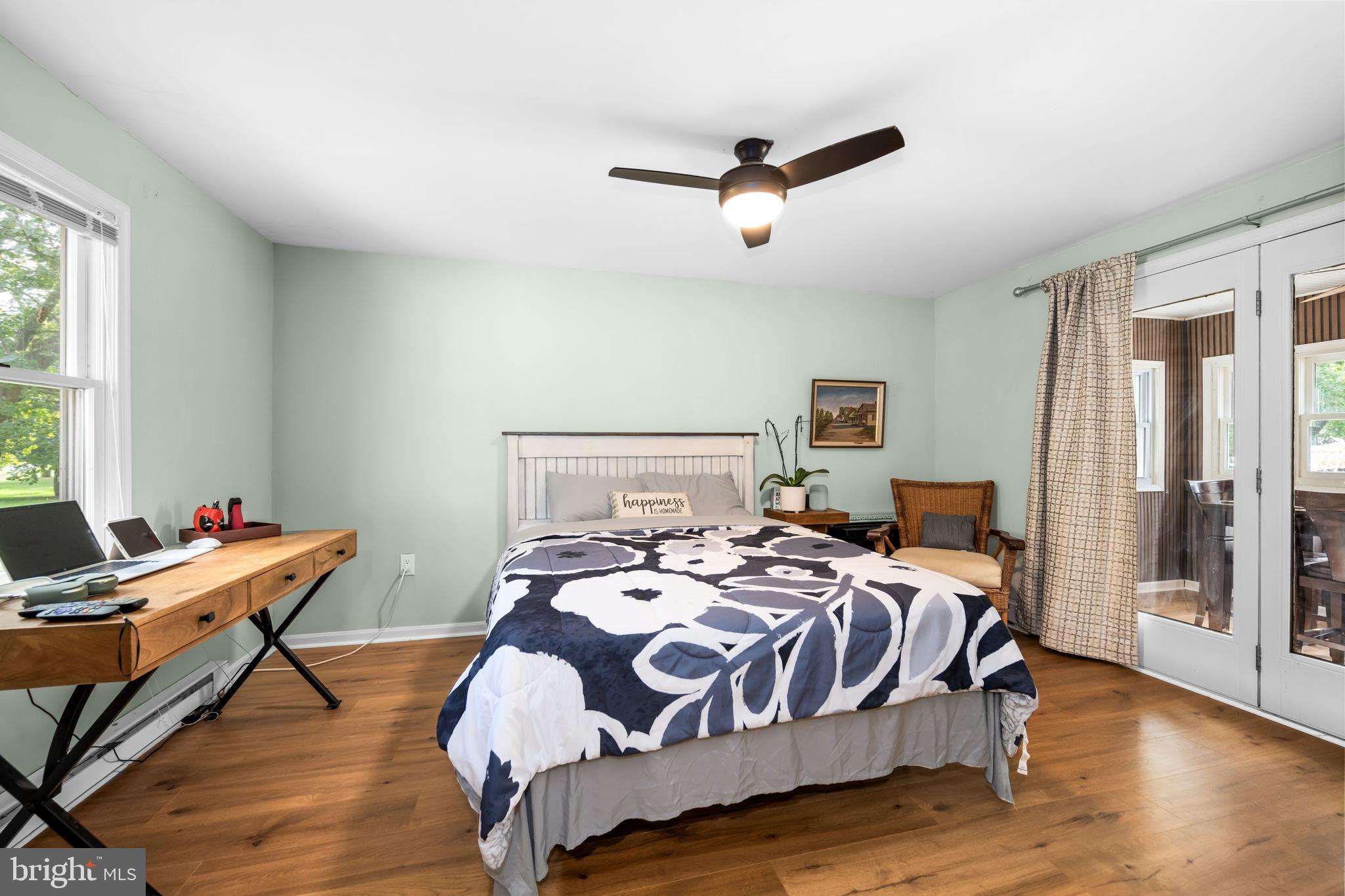 7653 Broad Neck Road Chestertown, MD 21620 - Photo 30 of 39 a bedroom with a bed and wooden floor