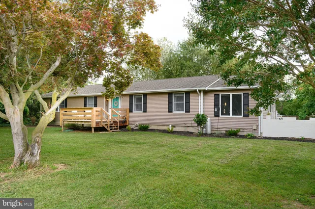 a front view of a house with a yard table and chairs