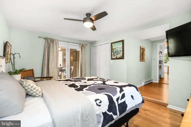 a bathroom with a granite countertop sink toilet a mirror and a window