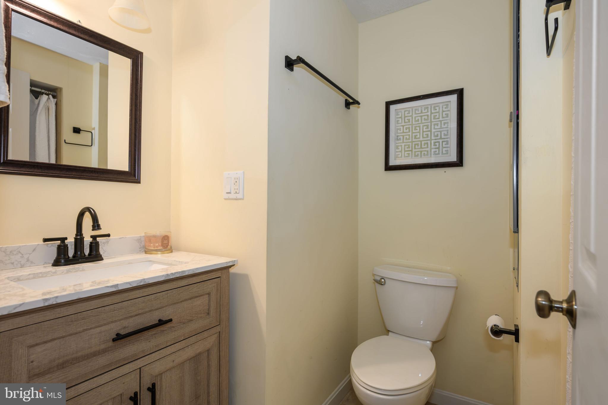 7653 Broad Neck Road Chestertown, MD 21620 - Photo 32 of 39 a bathroom with a toilet sink and mirror