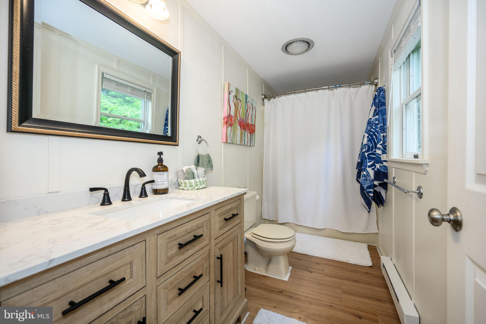 7653 Broad Neck Road Chestertown, MD 21620 - Photo 37 of 39 a bathroom with a granite countertop sink toilet and a mirror
