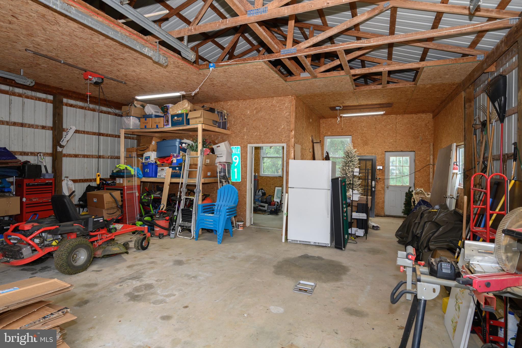 7653 Broad Neck Road Chestertown, MD 21620 - Photo 39 of 39 a view of a storage room with furniture fridge and stairs