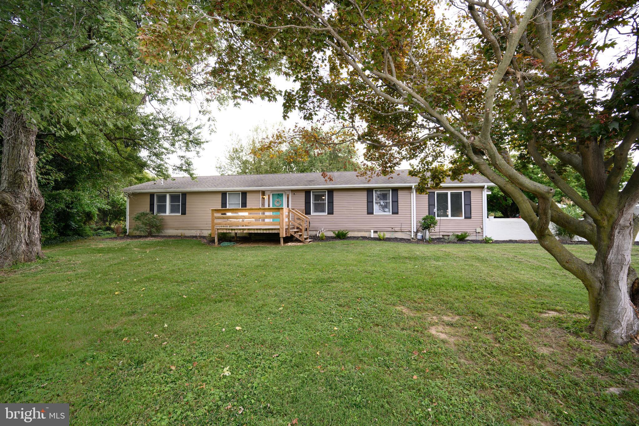 7653 Broad Neck Road Chestertown, MD 21620 - Photo 4 of 39 a front view of a house with a yard table and chairs