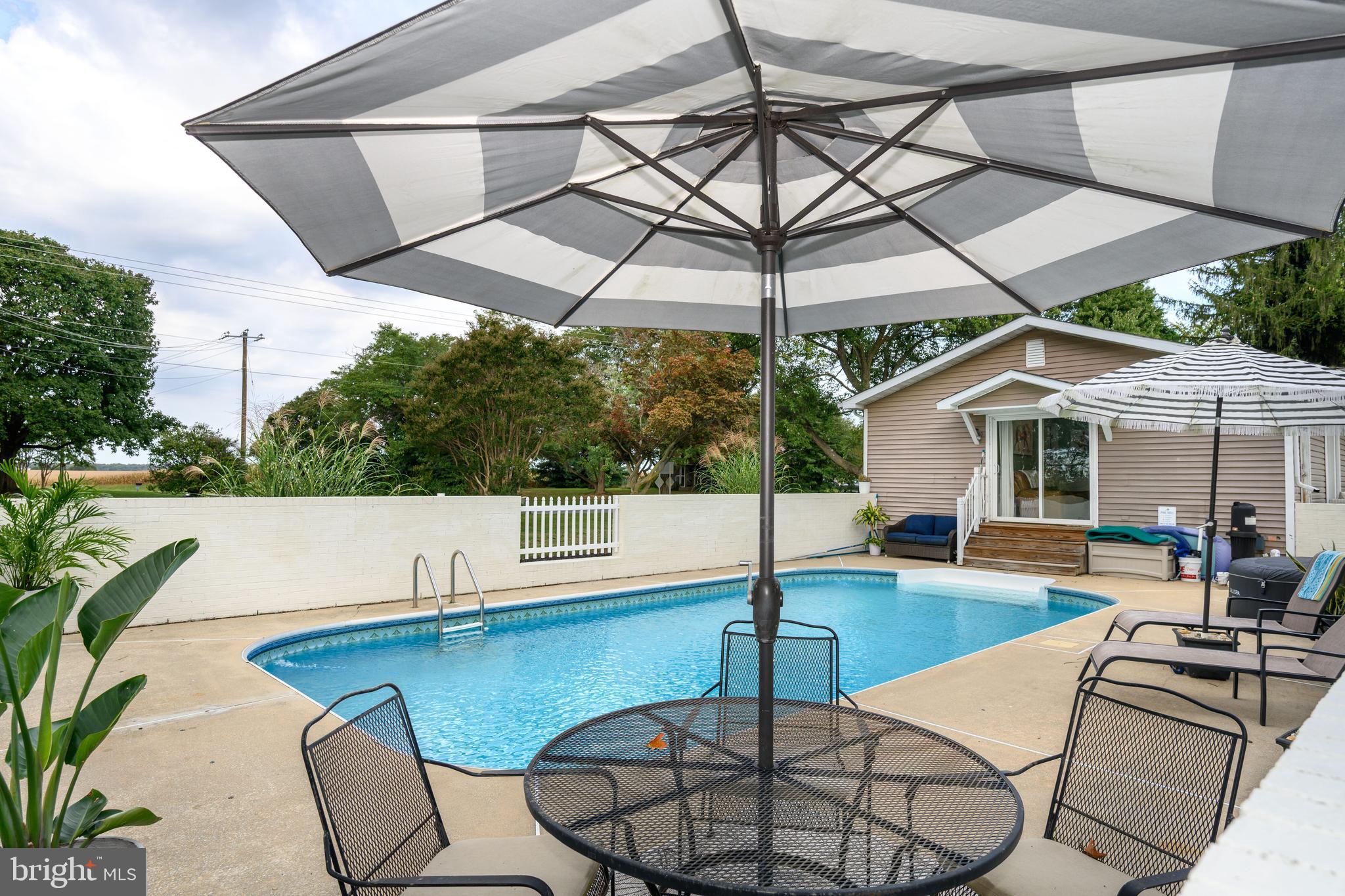 7653 Broad Neck Road Chestertown, MD 21620 - Photo 9 of 39 a patio with a yard table and chairs