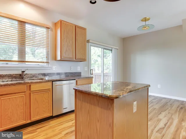a view of empty room with wooden floor and floor to ceiling window