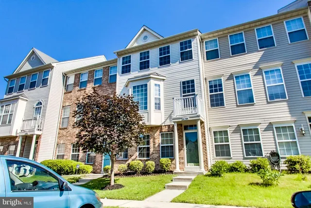 a front view of a residential apartment building with a yard