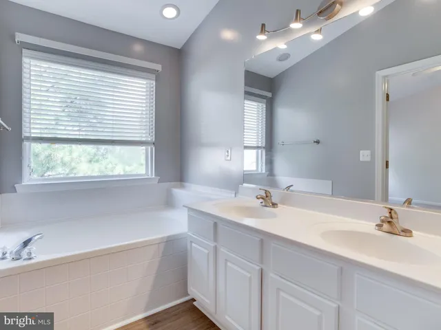 a bathroom with a shower a sink and toilet