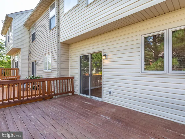 a view of a house with wooden deck