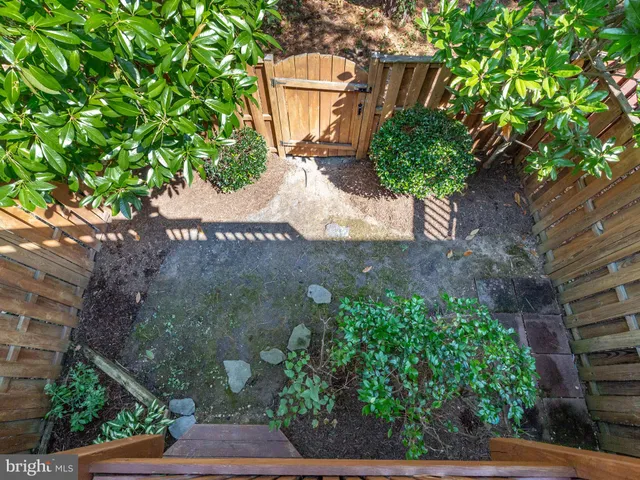 a view of a backyard with table and chairs and potted plants