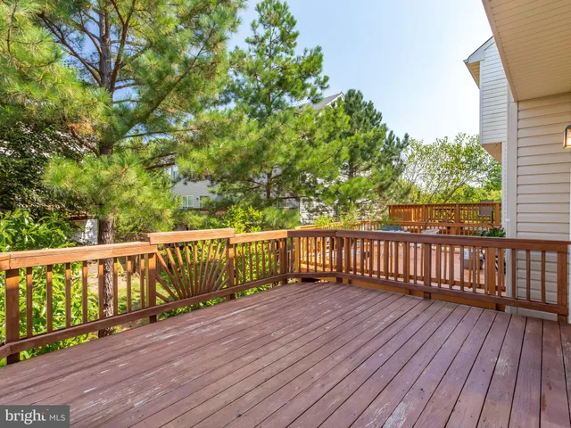 a balcony with wooden floor and fence