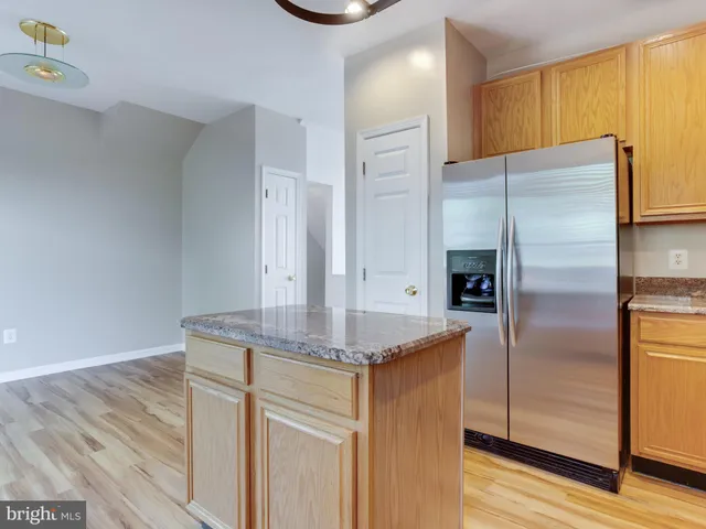 a kitchen with stainless steel appliances granite countertop a stove microwave and cabinets
