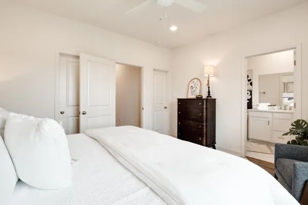 a bedroom with a bed and a dresser