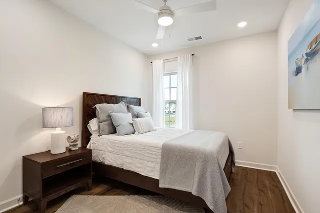 a bedroom with a bed and a night stand