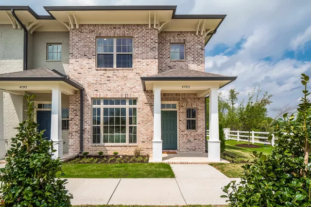 front view of a house with a small yard