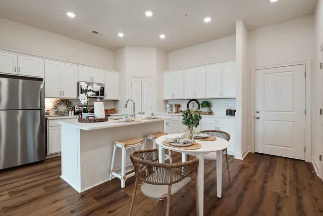 a kitchen with a table and chairs in it