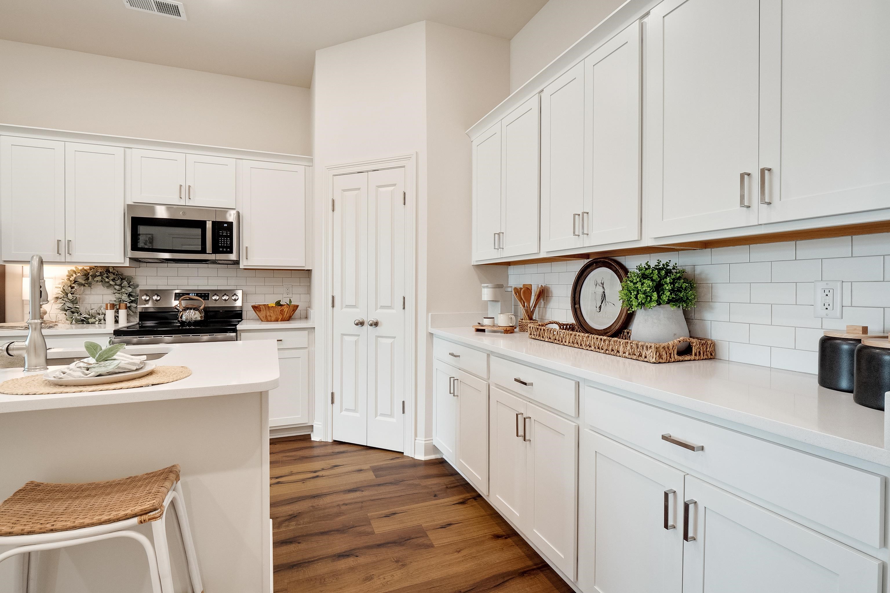 4793 South Houston Levee Road Collierville, TN 38017 - Photo 8 of 20 a kitchen with white cabinets and appliances