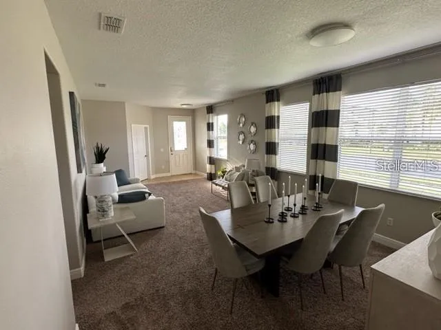 a view of a dining room with furniture and window