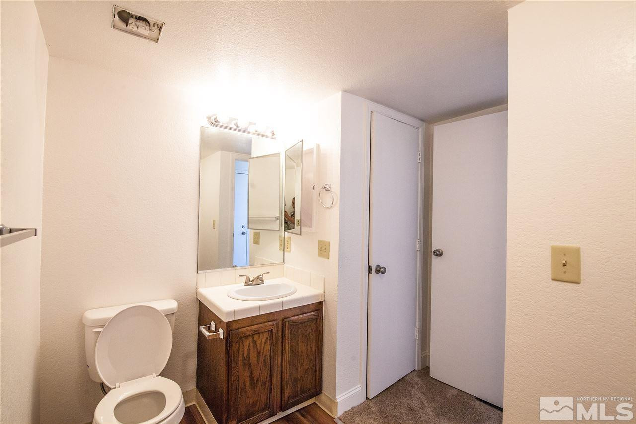 6945 Forsythia Way Reno, NV 89506 - Photo 15 of 17 a bathroom with a granite countertop sink and a mirror