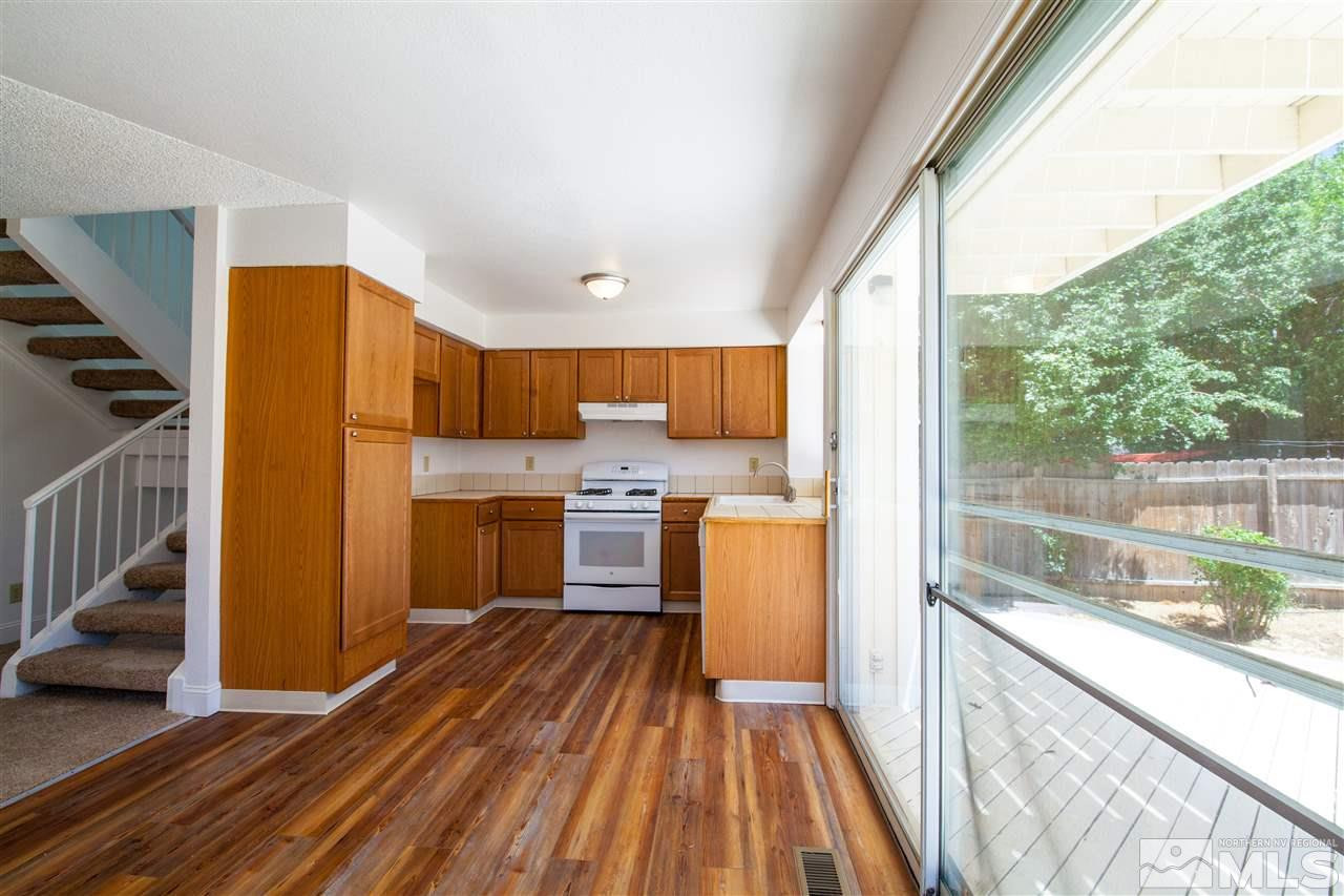 6945 Forsythia Way Reno, NV 89506 - Photo 3 of 17 a view of a kitchen with wooden floor and electronic appliances