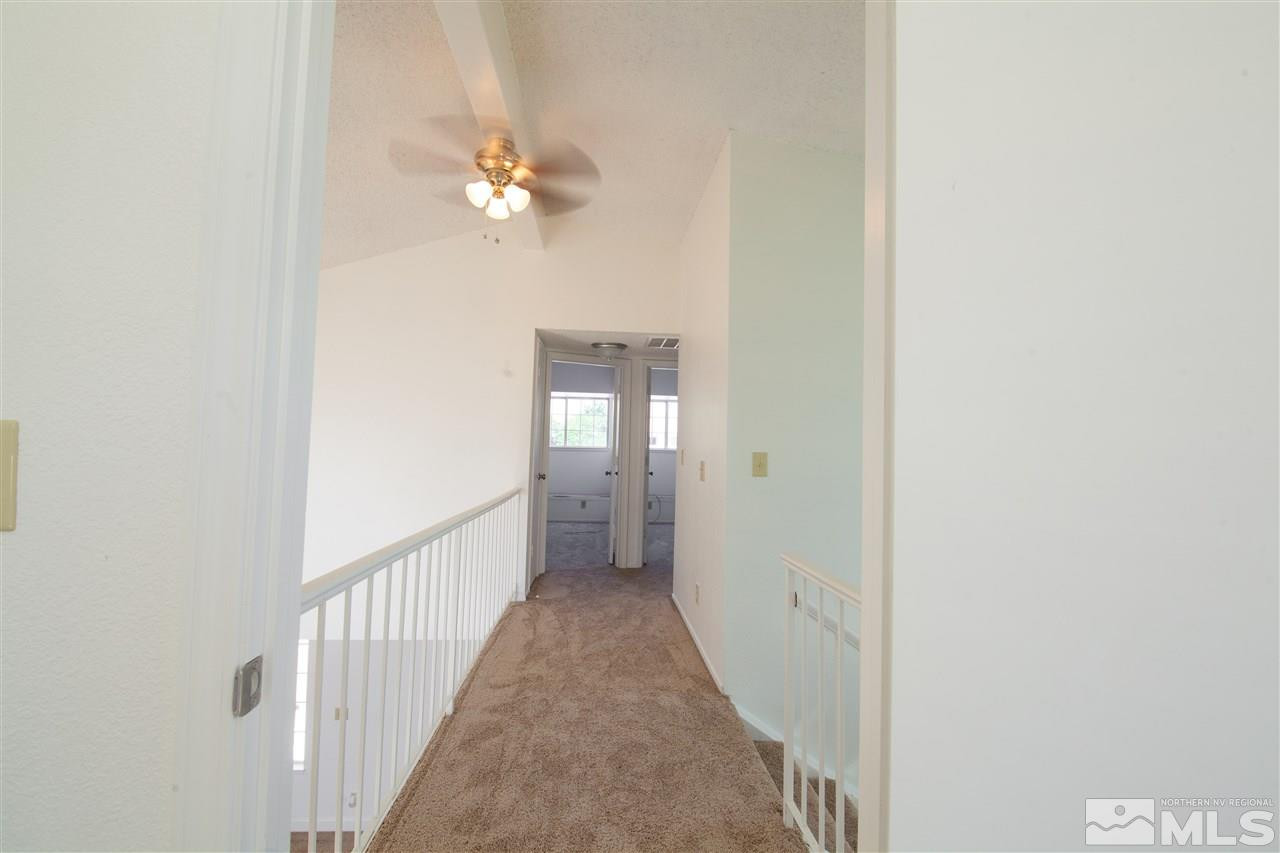 6945 Forsythia Way Reno, NV 89506 - Photo 8 of 17 a view of a hallway with a chandelier