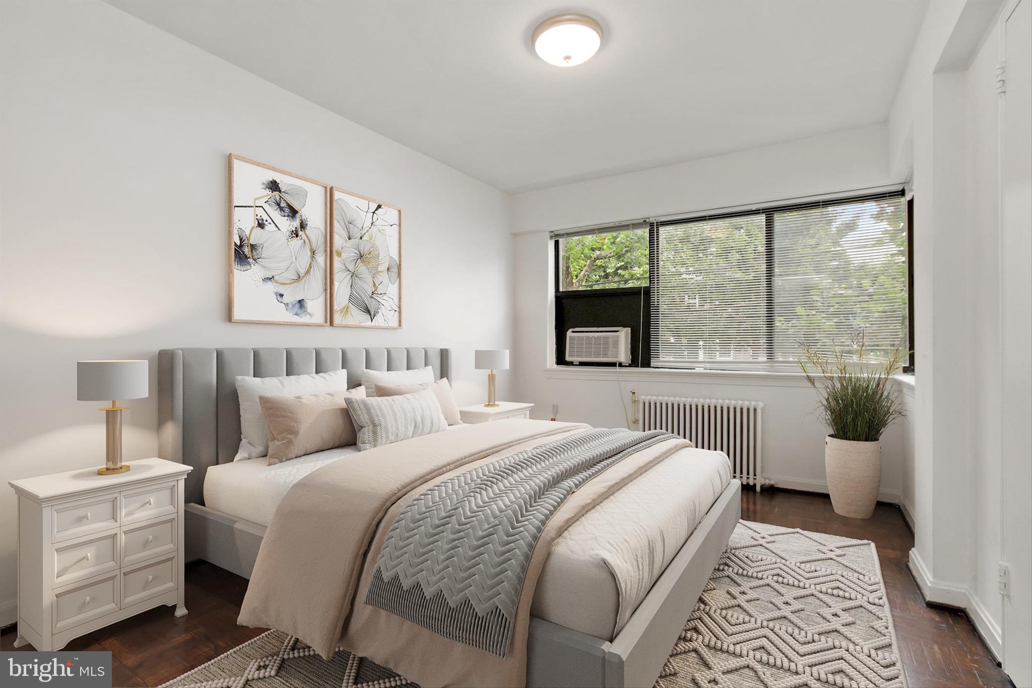 3901 Tunlaw Road Northwest, Unit 506 Washington, DC 20007 - Photo 10 of 21 a bedroom with a large bed and a window