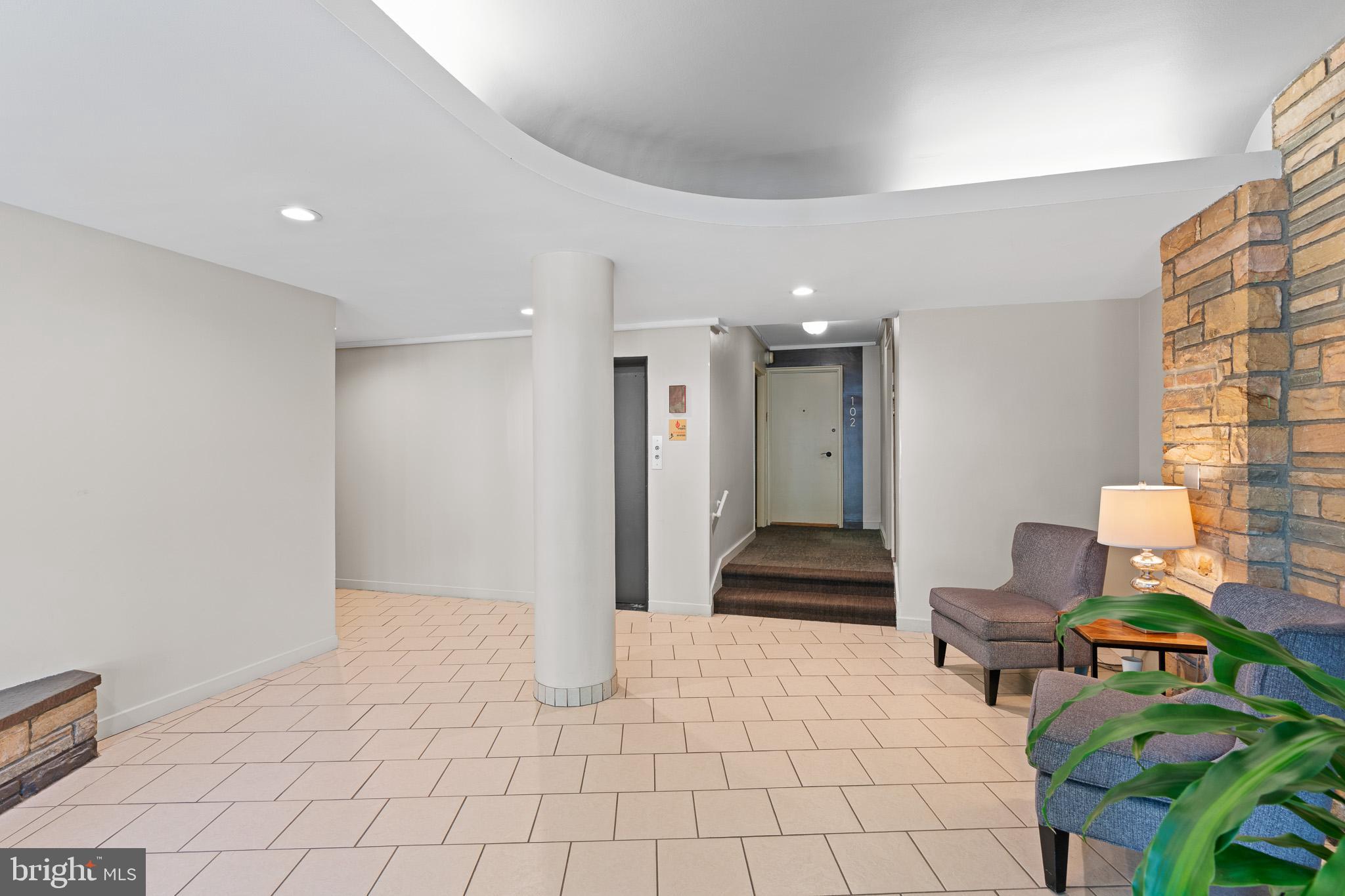 3901 Tunlaw Road Northwest, Unit 506 Washington, DC 20007 - Photo 17 of 21 a hallway with a dining table and chairs