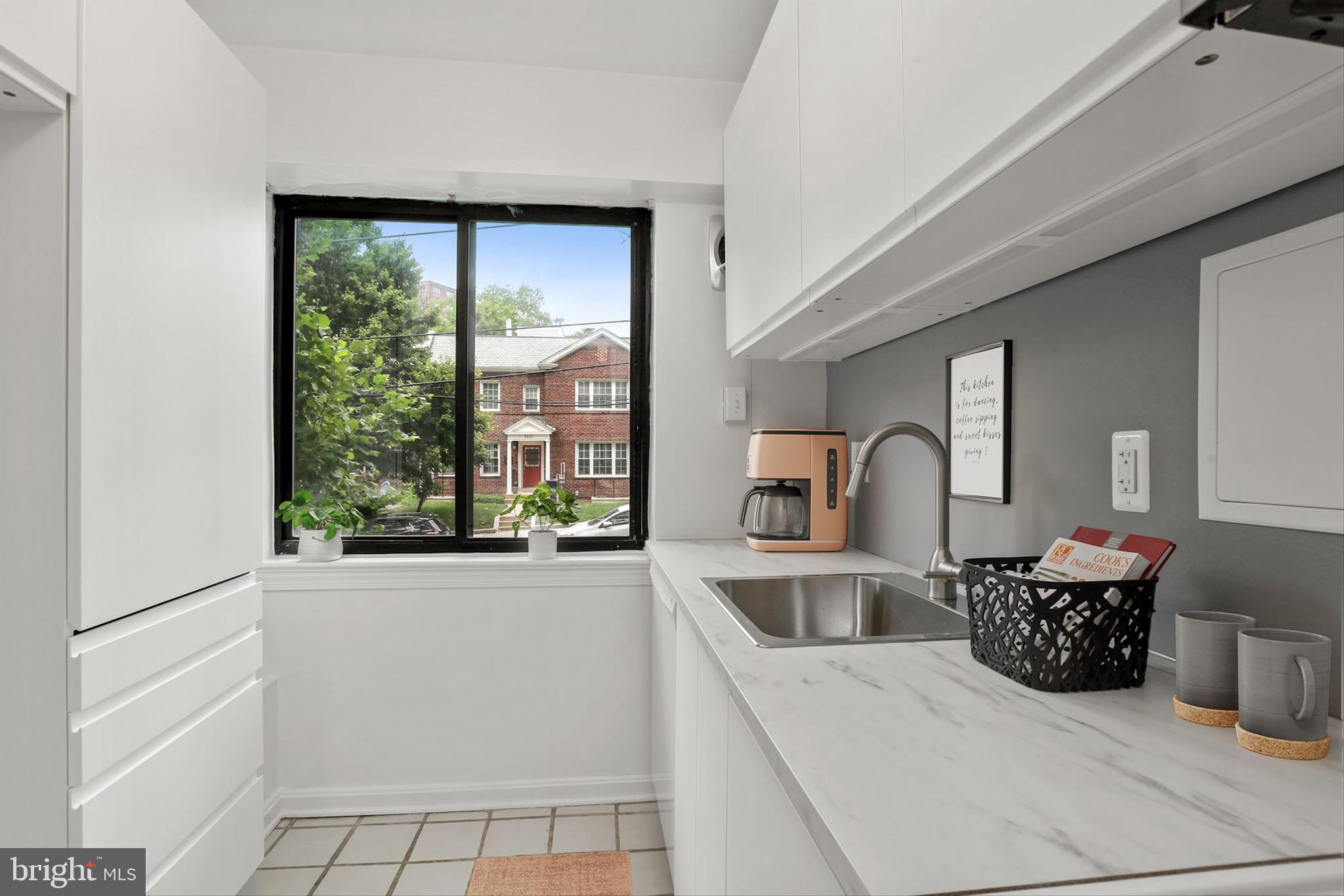 3901 Tunlaw Road Northwest, Unit 506 Washington, DC 20007 - Photo 3 of 21 a kitchen with a refrigerator and a sink