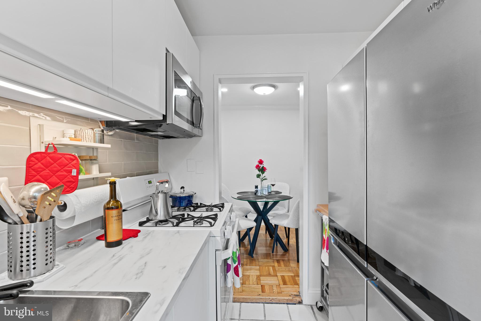 3901 Tunlaw Road Northwest, Unit 506 Washington, DC 20007 - Photo 4 of 21 a view of a room with lots of stuff and hardwood floor