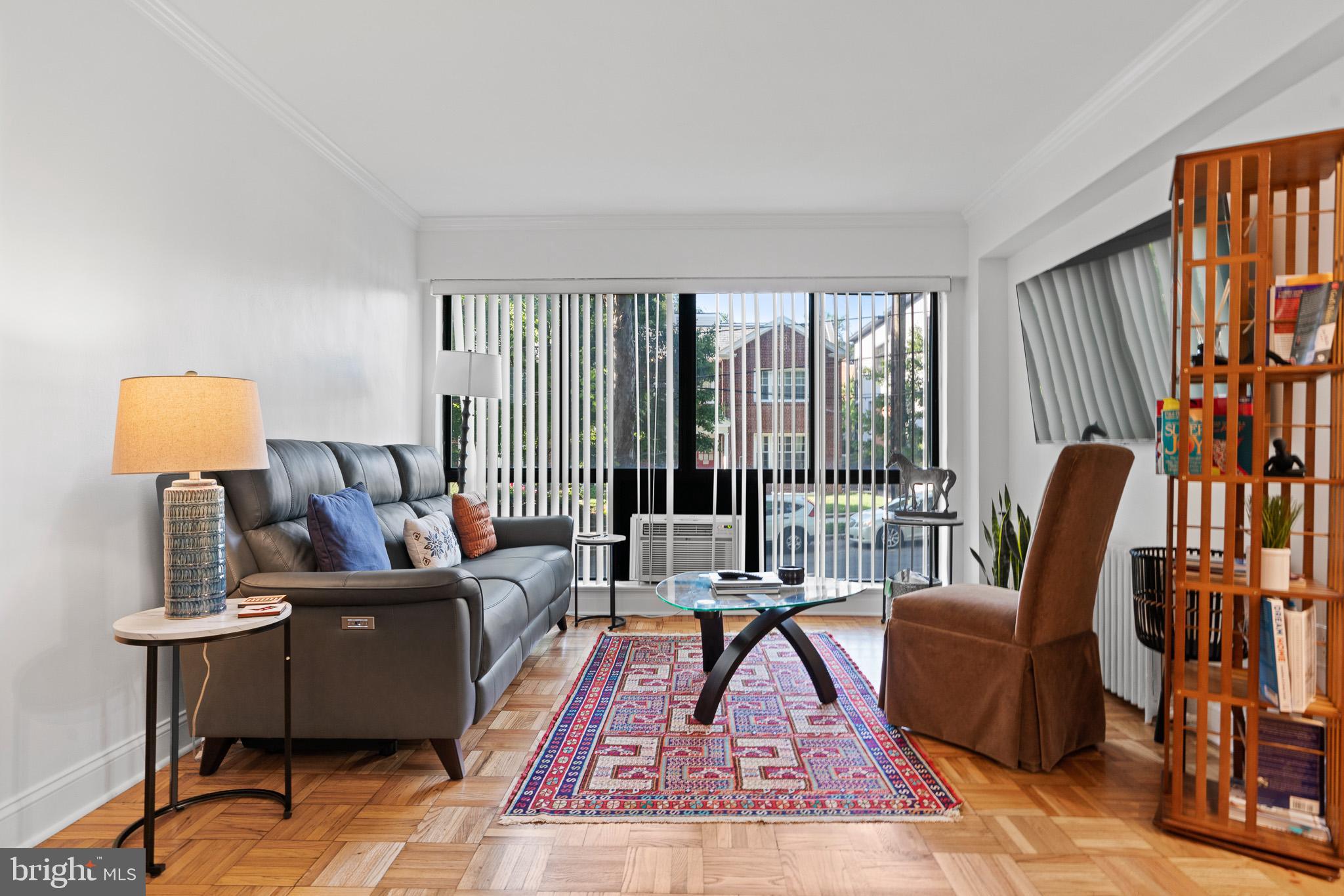 3901 Tunlaw Road Northwest, Unit 506 Washington, DC 20007 - Photo 6 of 21 a living room with furniture and large window
