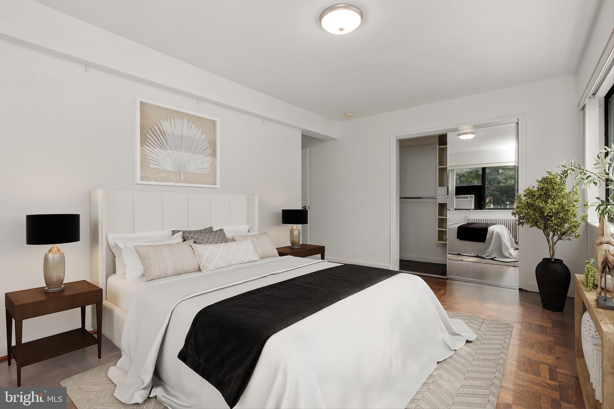 3901 Tunlaw Road Northwest, Unit 506 Washington, DC 20007 - Photo 9 of 21 a bedroom with a large bed and view of living room