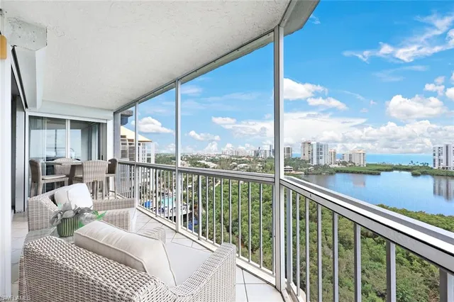 a view of a balcony with couches and wooden floor