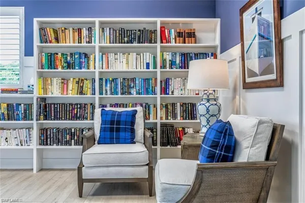 a living room with furniture and a book shelf