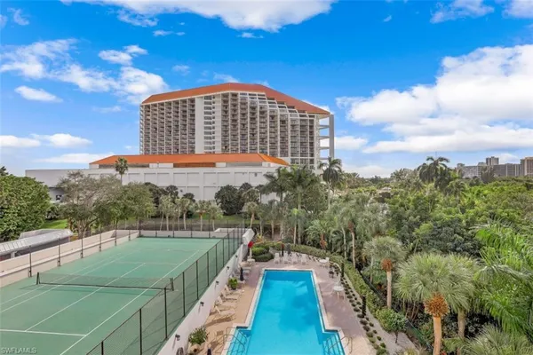 a view of a swimming pool with a yard
