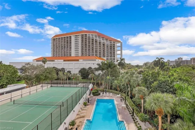 a view of a swimming pool with a yard