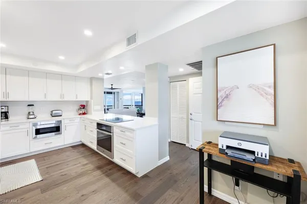 a kitchen with a stove and white cabinets