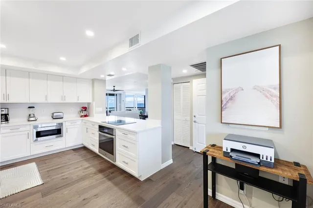 a kitchen with a stove and white cabinets